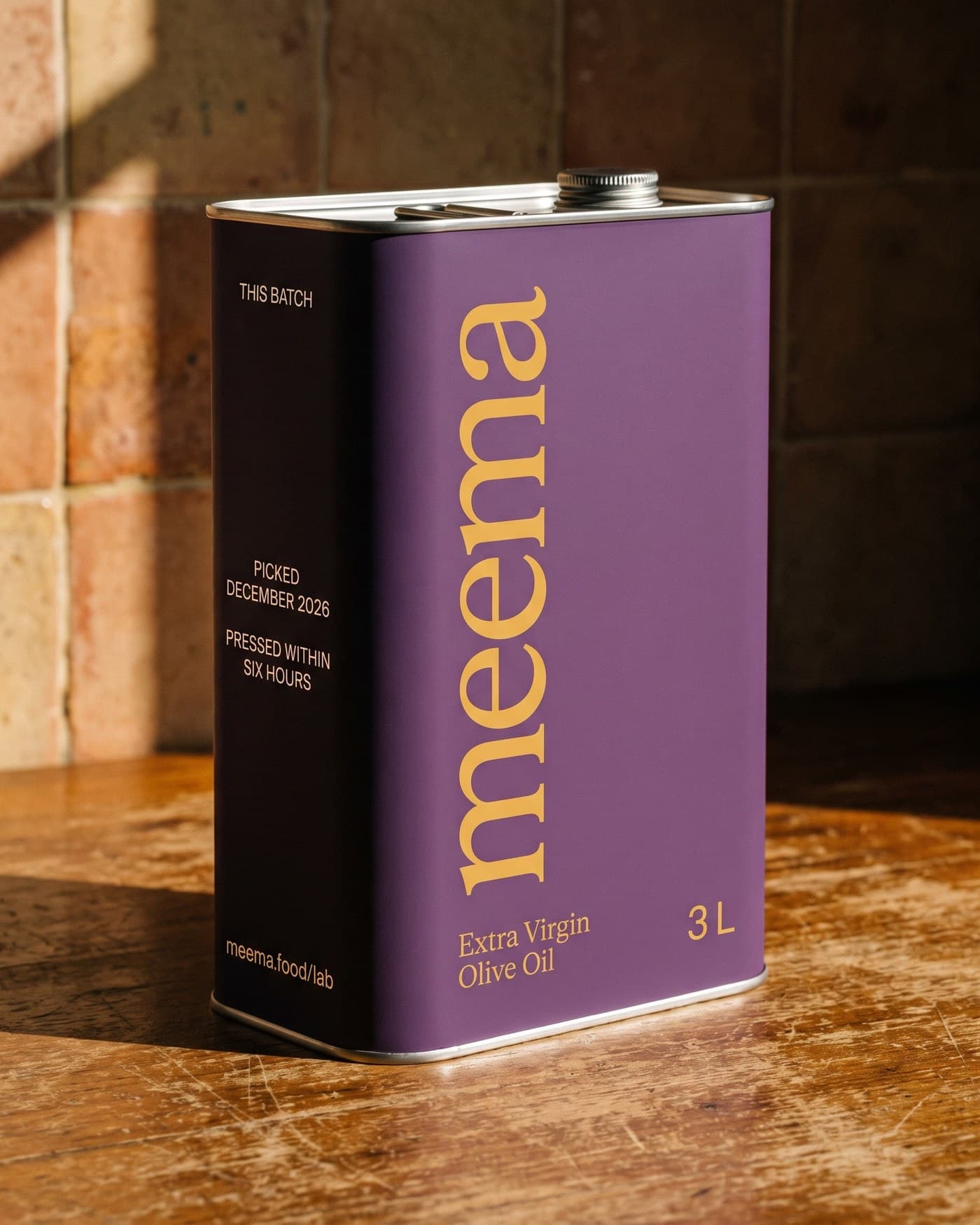 The Meema 101 fl oz tin: aubergine, gold wordmark, with the batch details printed down the side panel